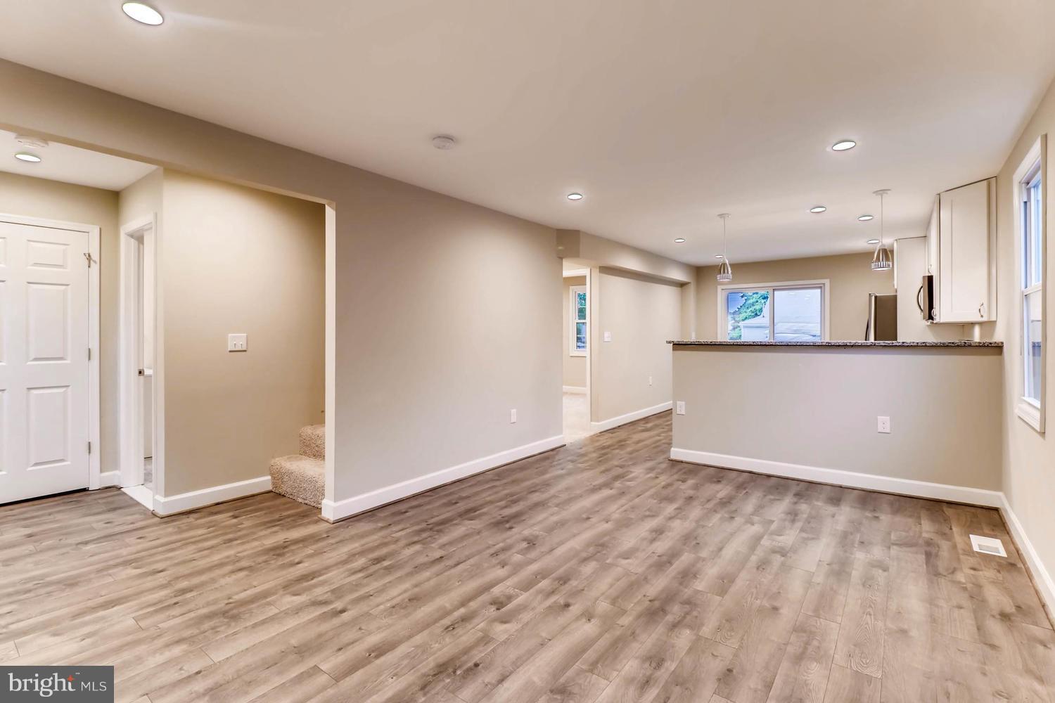 8103 Bullneck Road Baltimore, MD 21222 - Photo 4 of 26 an empty room with wooden floor and windows