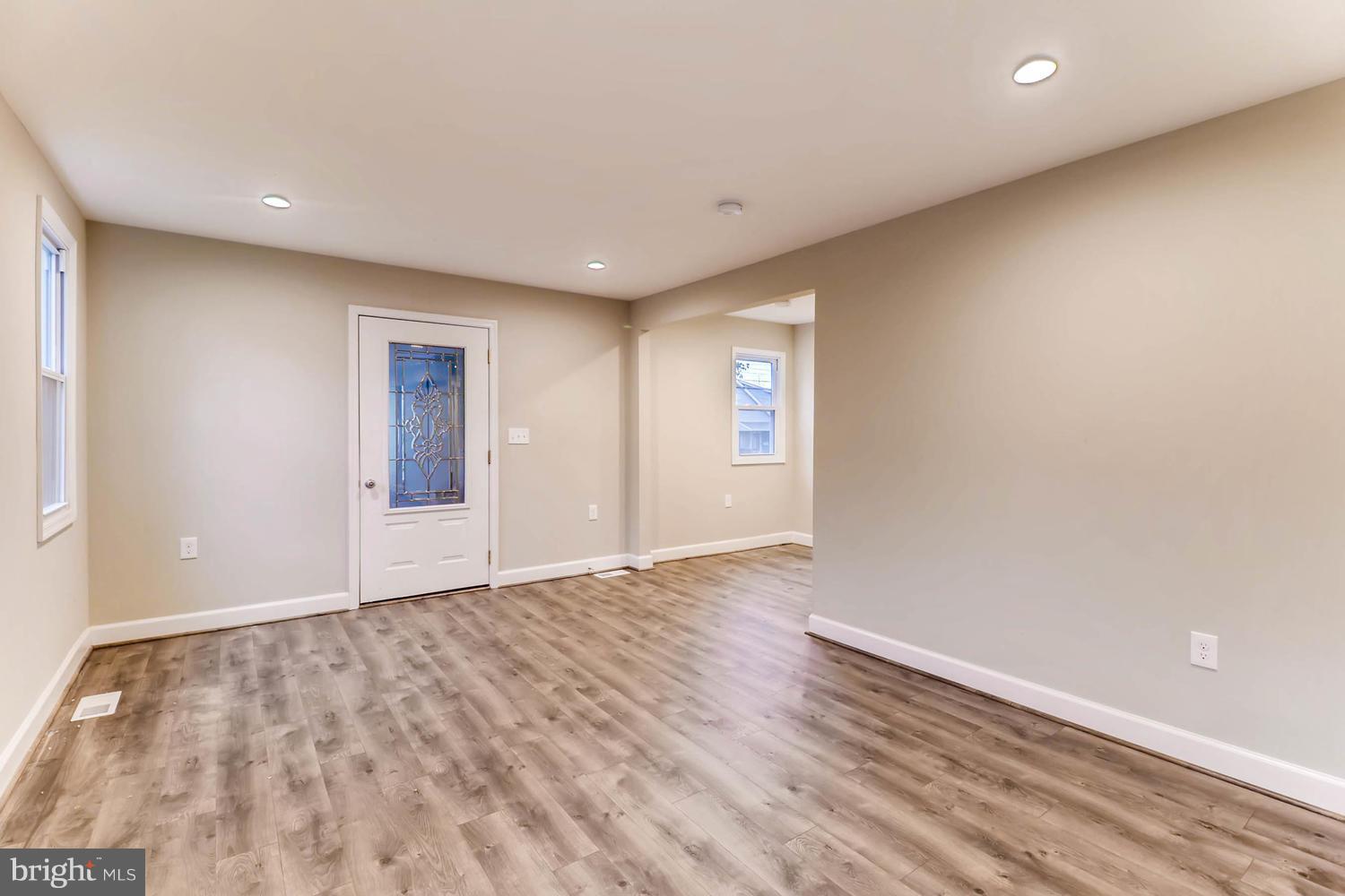 8103 Bullneck Road Baltimore, MD 21222 - Photo 5 of 26 an empty room with wooden floor and windows