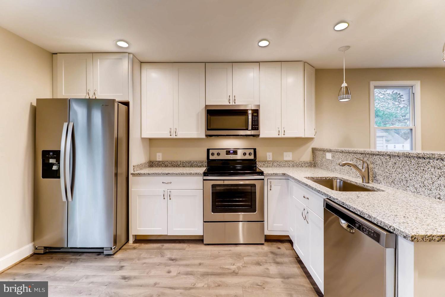 8103 Bullneck Road Baltimore, MD 21222 - Photo 7 of 26 a kitchen with a sink stove and refrigerator