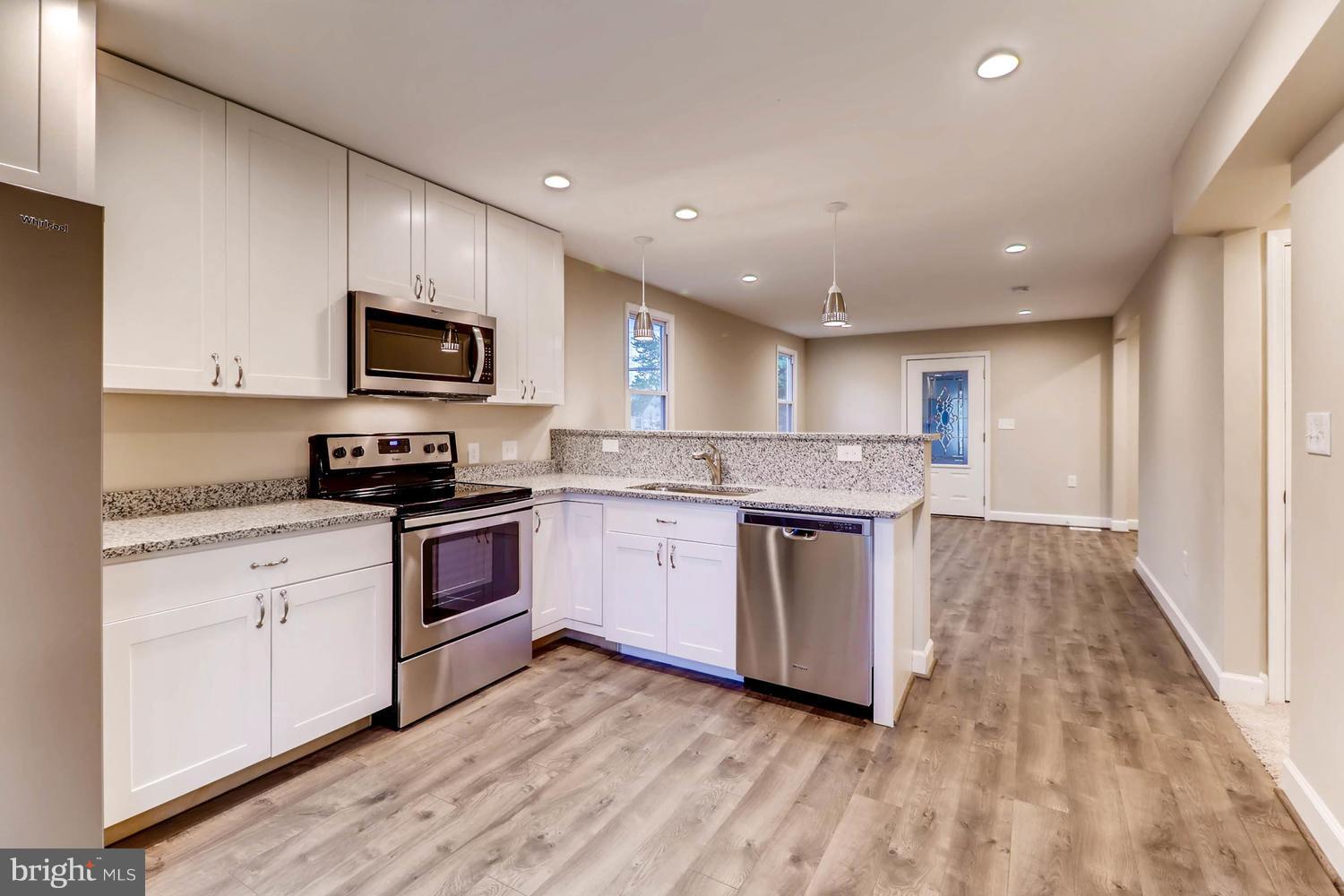 8103 Bullneck Road Baltimore, MD 21222 - Photo 8 of 26 a kitchen with a stove top oven a sink and a microwave