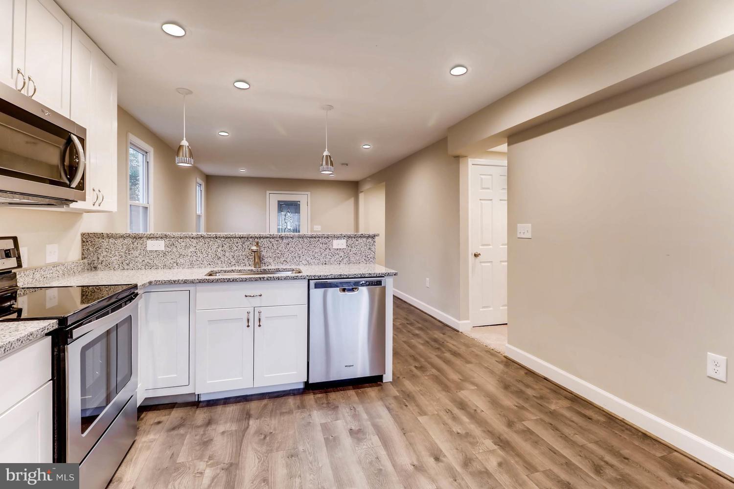 8103 Bullneck Road Baltimore, MD 21222 - Photo 9 of 26 a large kitchen with granite countertop a stove and a sink