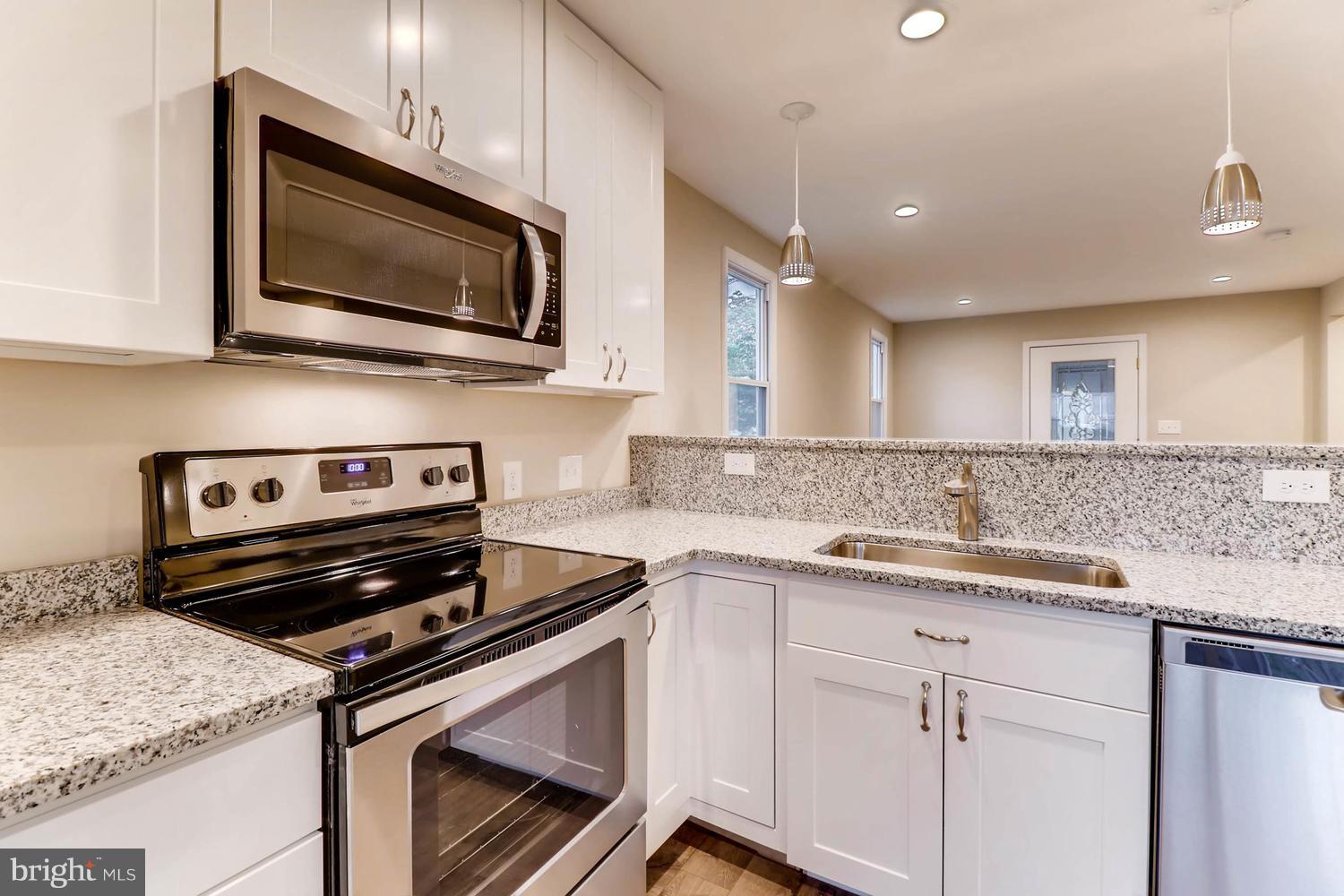 8103 Bullneck Road Baltimore, MD 21222 - Photo 10 of 26 a kitchen with a sink stove and microwave