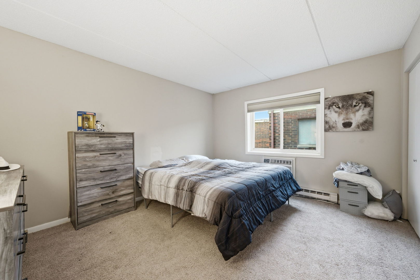 940 North Rohlwing Road, Unit 201A Addison, IL 60101 - Photo 11 of 15 a bedroom with a bed and a window