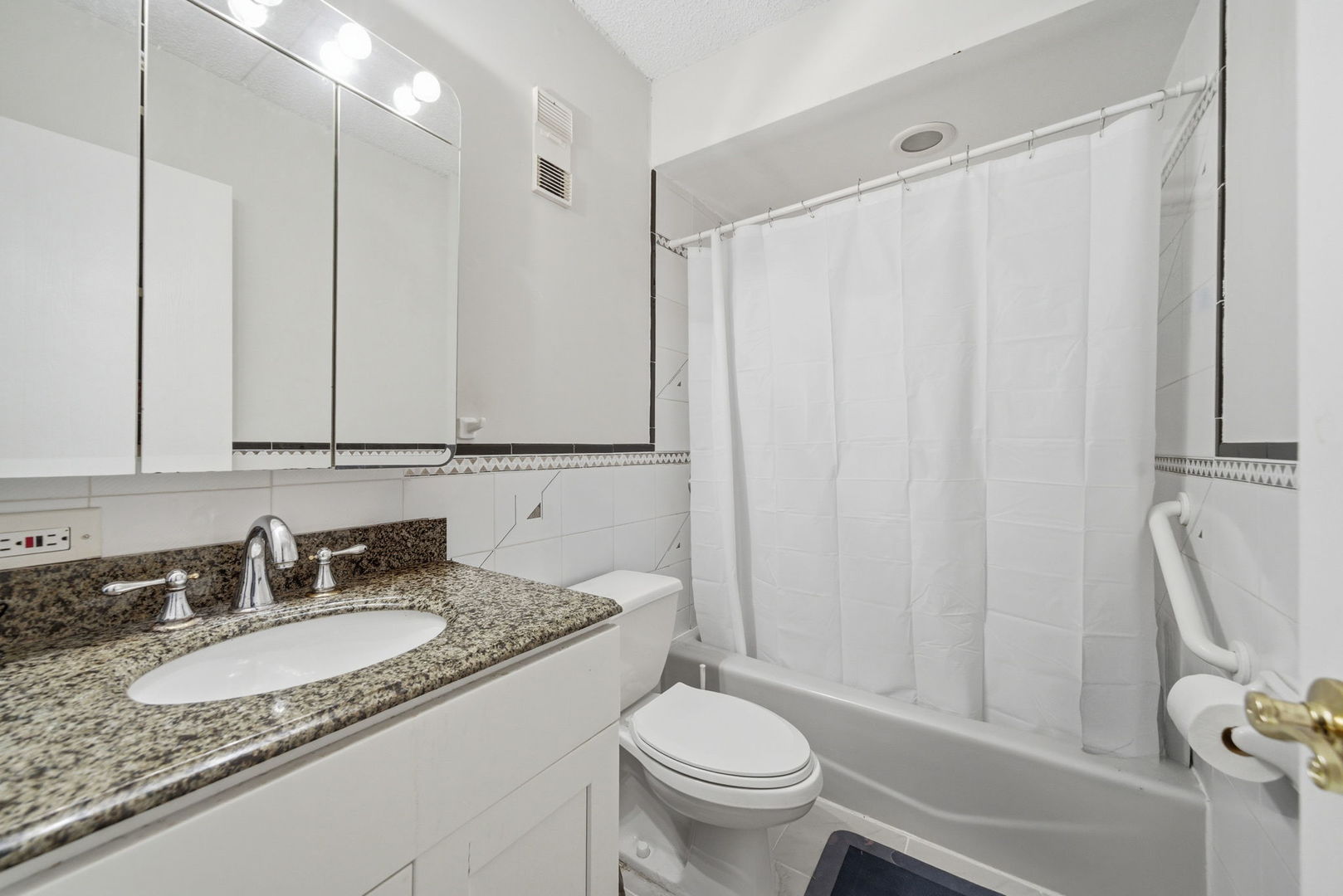 940 North Rohlwing Road, Unit 201A Addison, IL 60101 - Photo 12 of 15 a bathroom with a granite countertop sink and a mirror