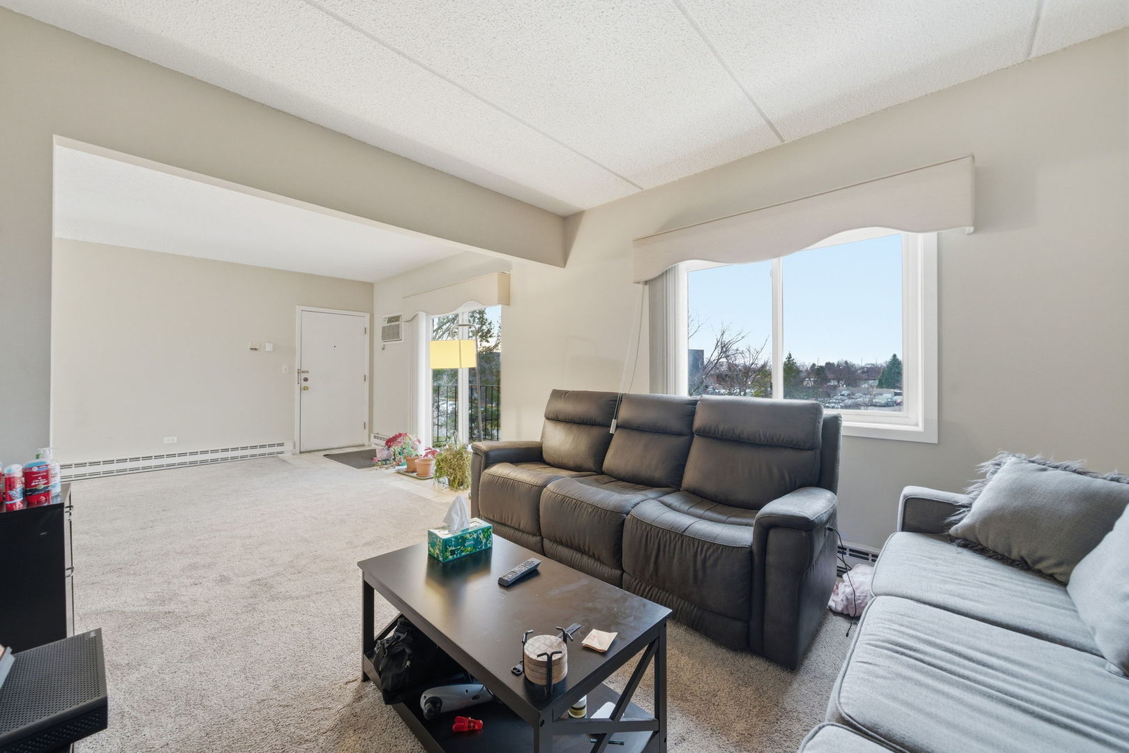 940 North Rohlwing Road, Unit 201A Addison, IL 60101 - Photo 4 of 15 a living room with furniture and a gate