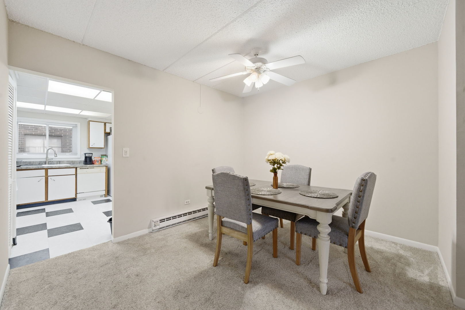 940 North Rohlwing Road, Unit 201A Addison, IL 60101 - Photo 5 of 15 a view of a dining room with furniture and a chandelier fan