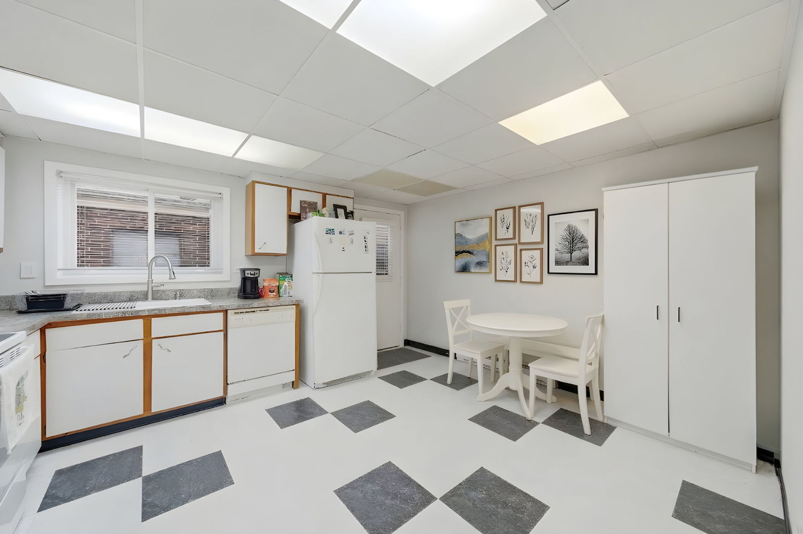 940 North Rohlwing Road, Unit 201A Addison, IL 60101 - Photo 6 of 15 a kitchen with a white cabinets and white appliances