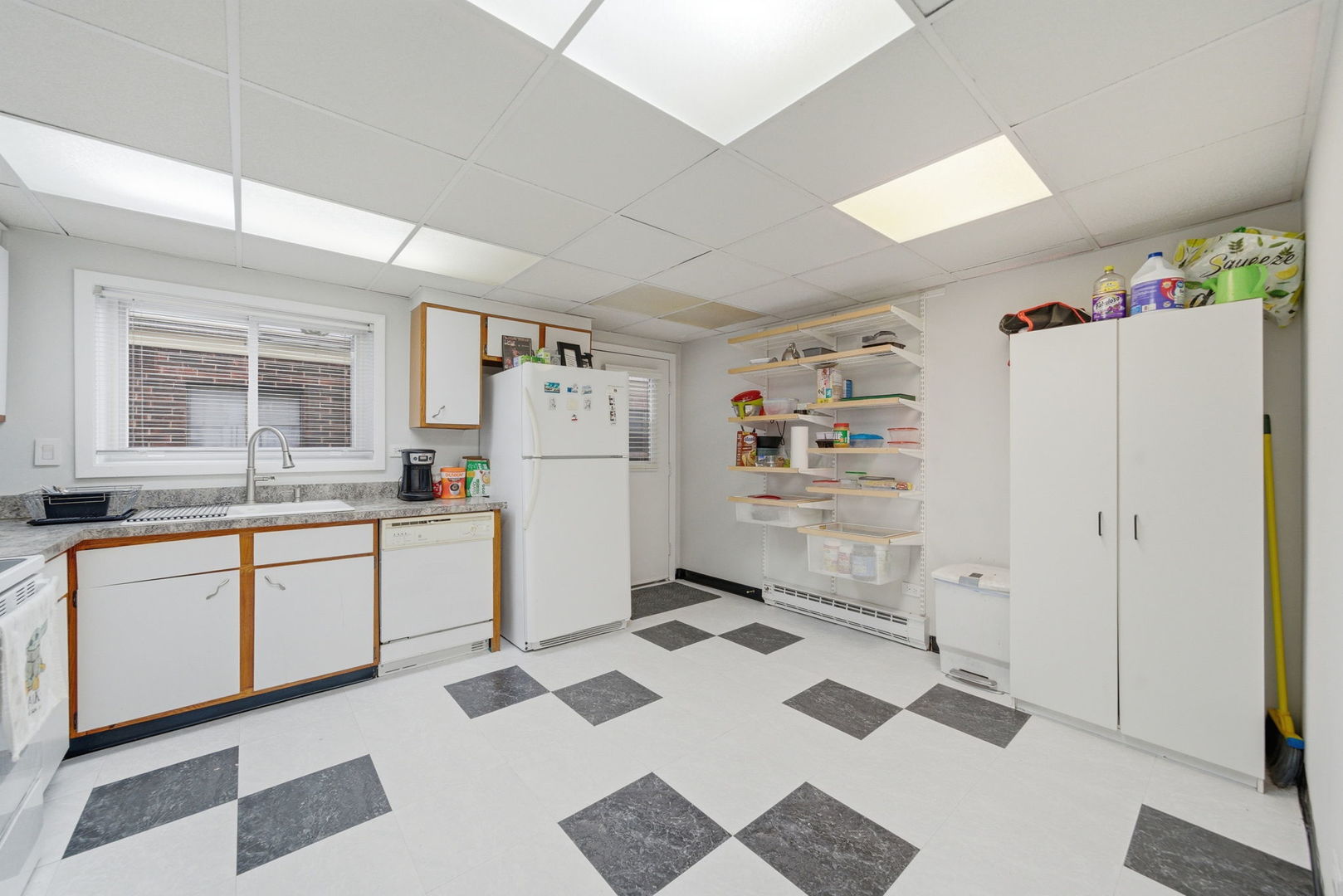 940 North Rohlwing Road, Unit 201A Addison, IL 60101 - Photo 7 of 15 a kitchen with a refrigerator and white cabinets