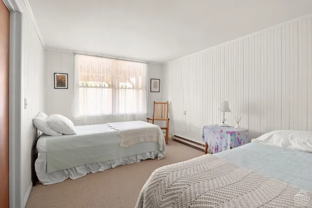 a bedroom with two beds and a window