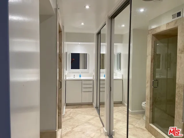 a bathroom with a shower and a glass door shower