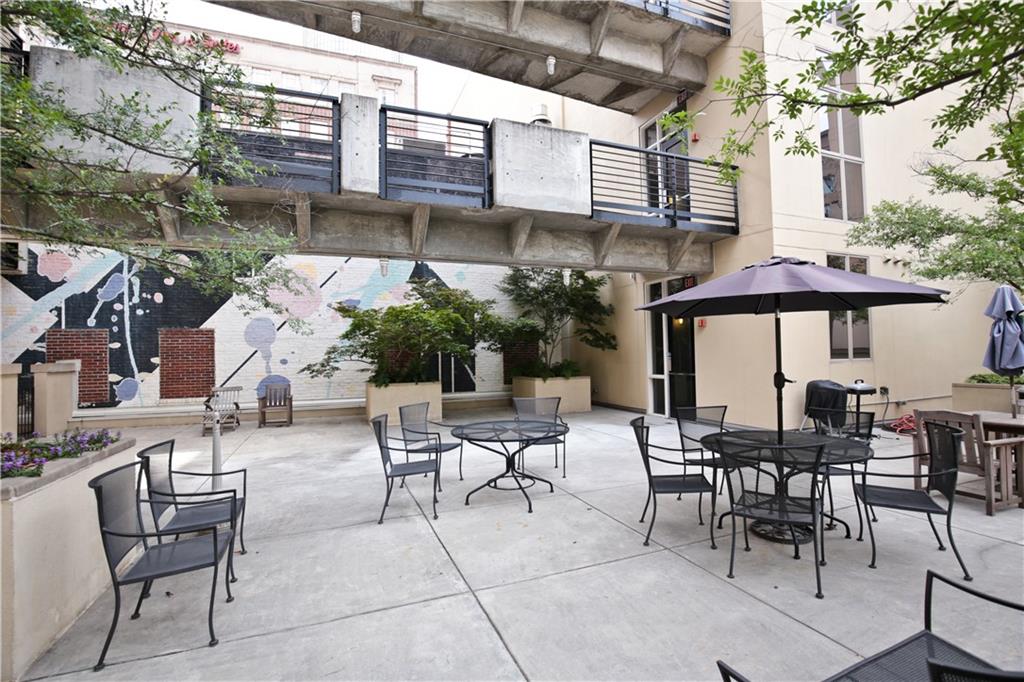 123 Luckie Street Northwest, Unit 2510 Atlanta, GA 30303 - Photo 27 of 28 a view of a patio with a table and chairs under an umbrella