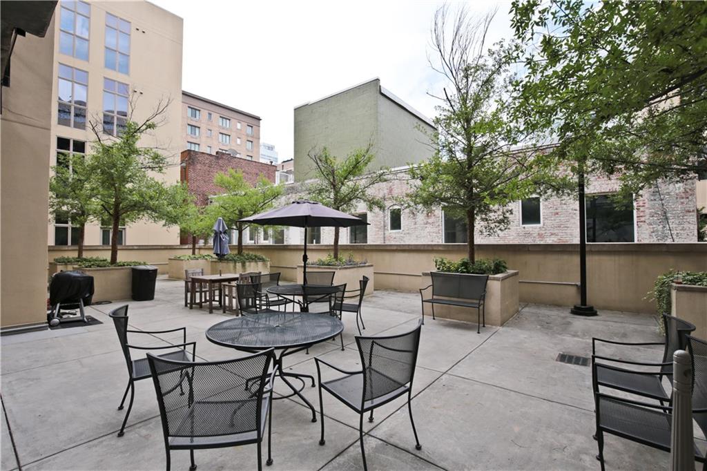 123 Luckie Street Northwest, Unit 2510 Atlanta, GA 30303 - Photo 28 of 28 a view of a patio with a table and chairs under an umbrella