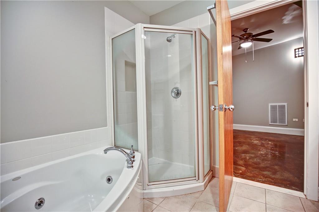123 Luckie Street Northwest, Unit 2510 Atlanta, GA 30303 - Photo 10 of 28 a bathroom with a bathtub and a shower