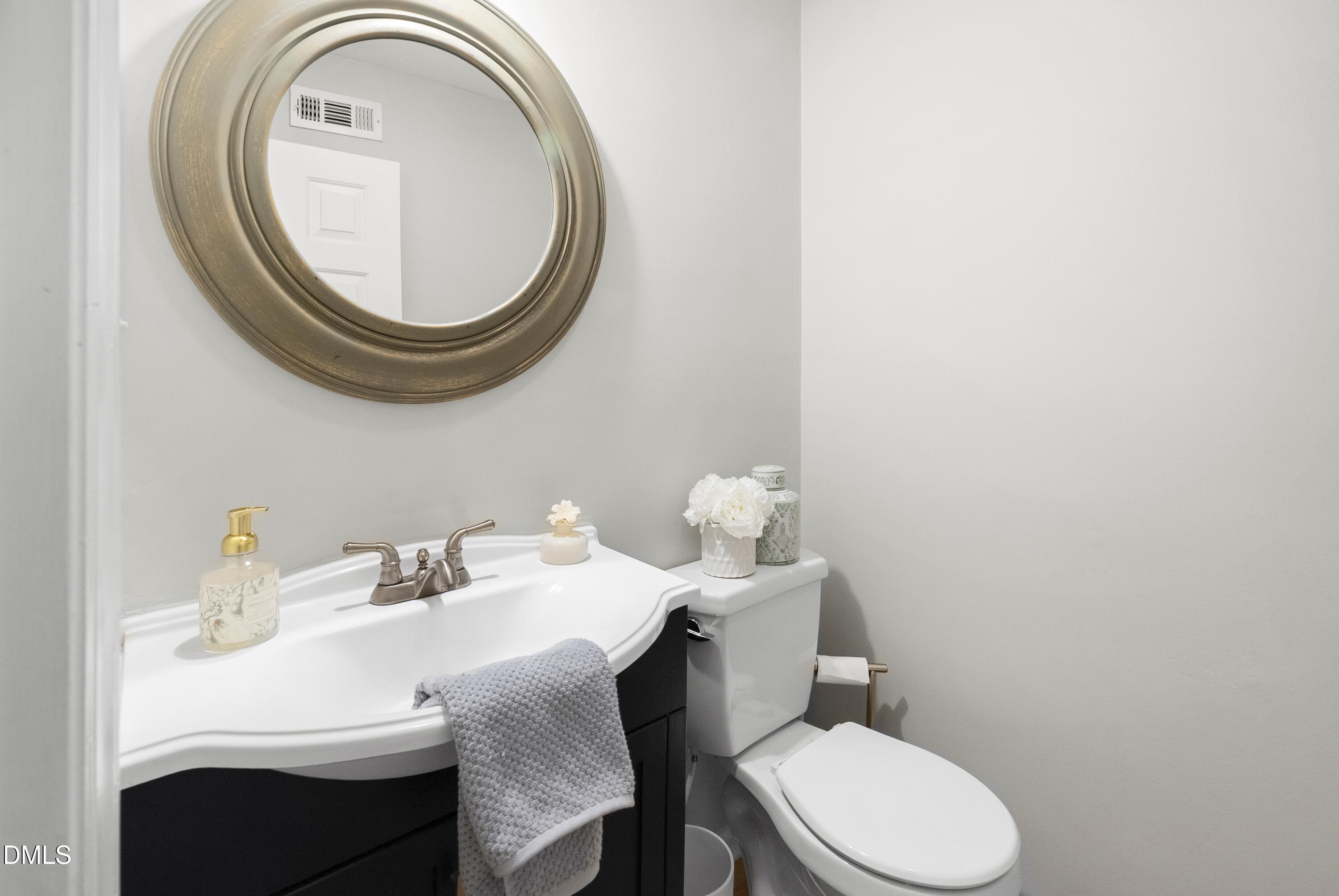 1515 Hemphill Drive Raleigh, NC 27609 - Photo 14 of 46 a bathroom with a sink mirror and toilet