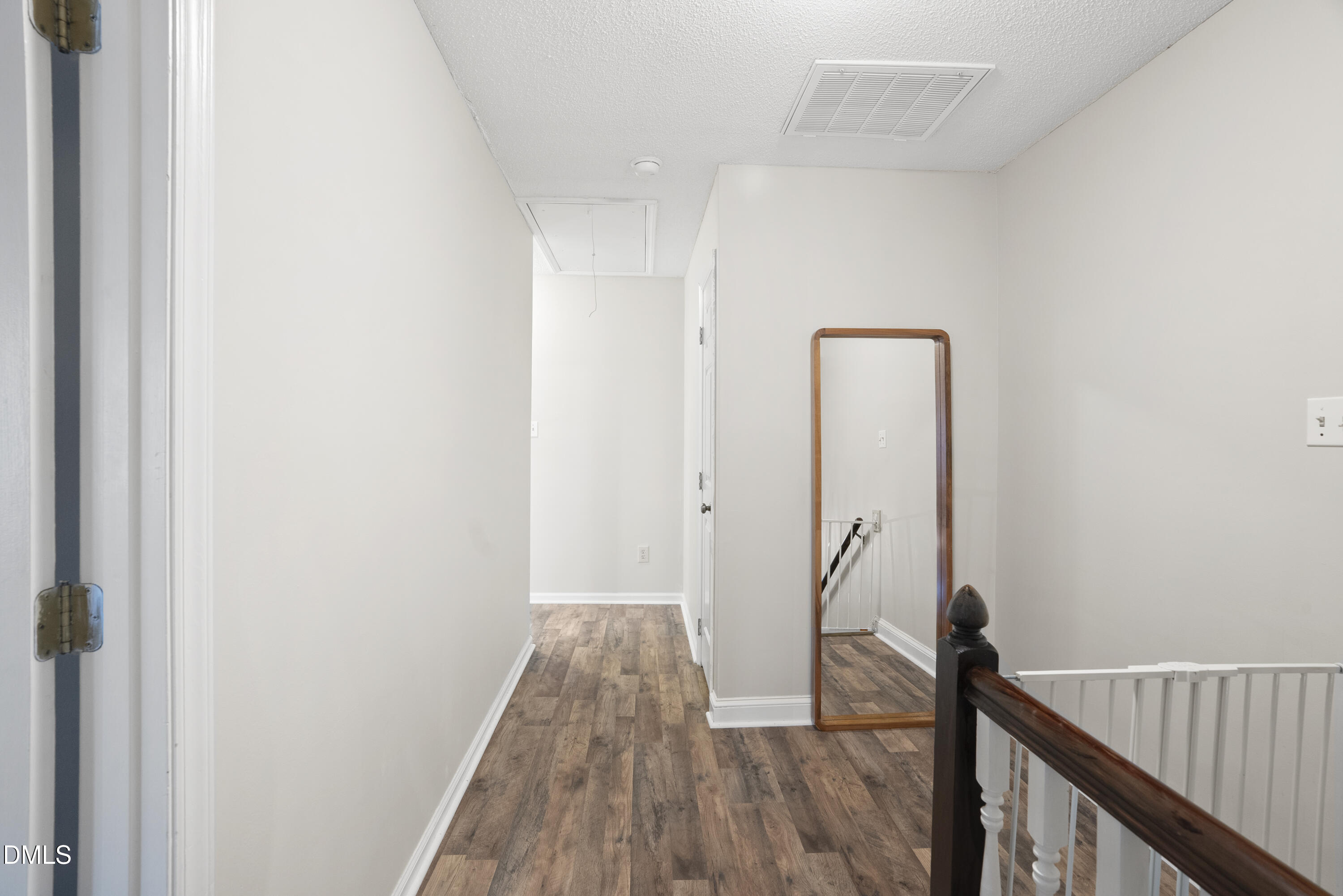 1515 Hemphill Drive Raleigh, NC 27609 - Photo 17 of 46 a view of a hallway with wooden floor and stairs