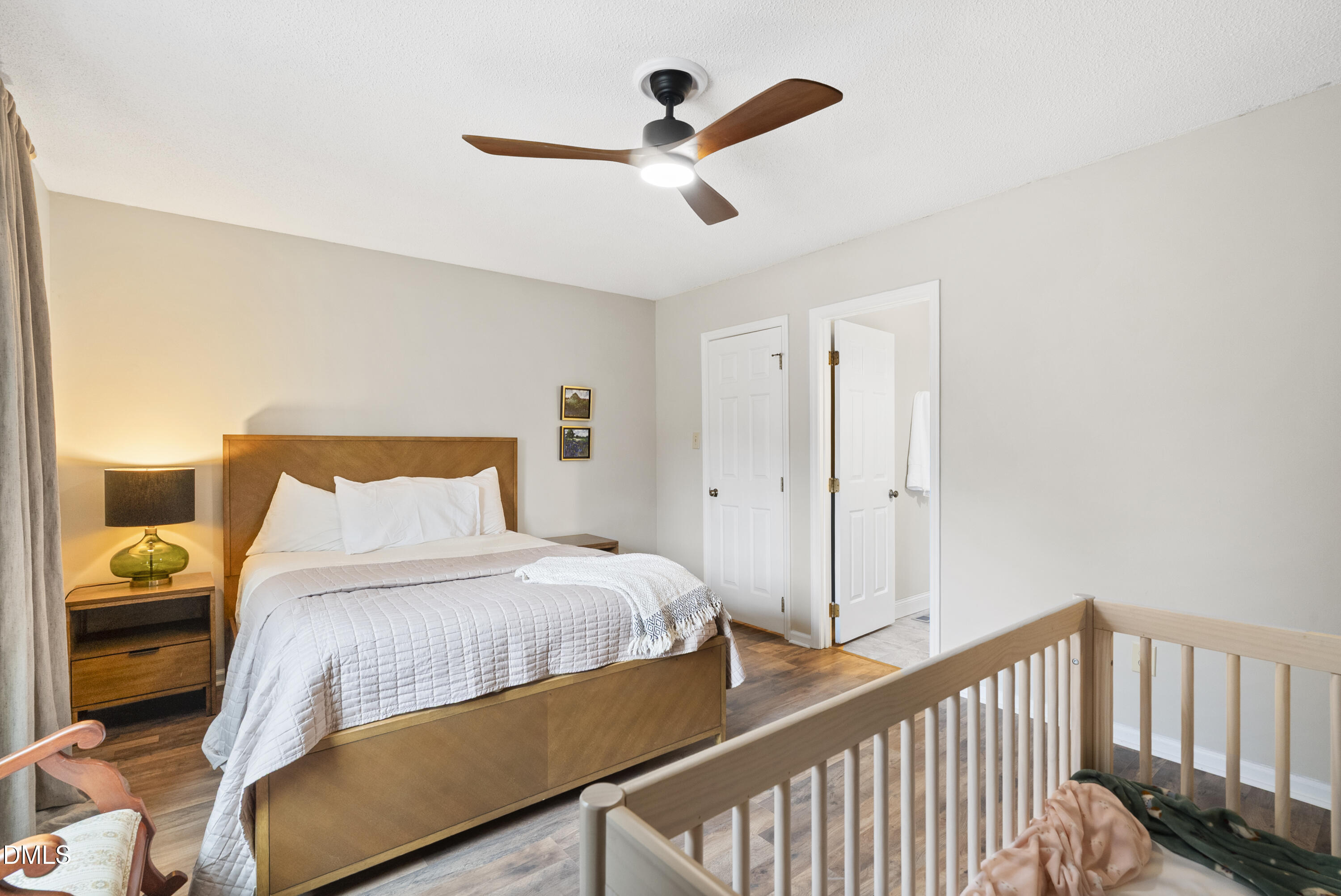 1515 Hemphill Drive Raleigh, NC 27609 - Photo 20 of 46 a bedroom with a bed and a chandelier