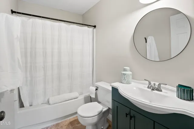 a bathroom with a sink toilet and a mirror