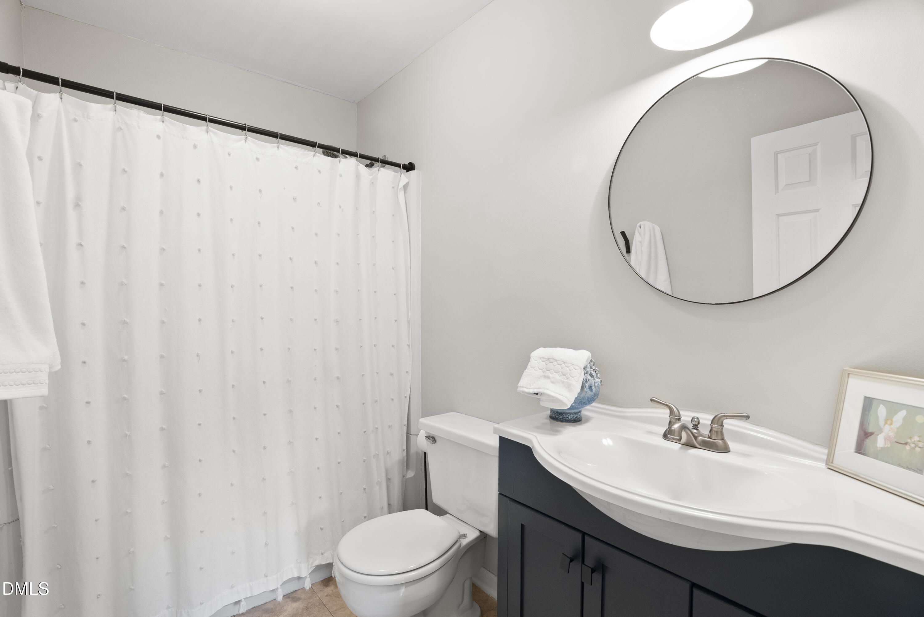 1515 Hemphill Drive Raleigh, NC 27609 - Photo 25 of 46 a bathroom with a sink a toilet and a mirror