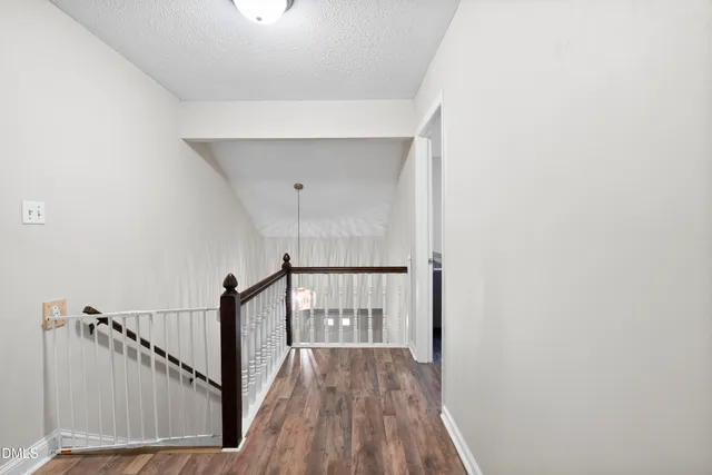 a view of hallway with wooden floor
