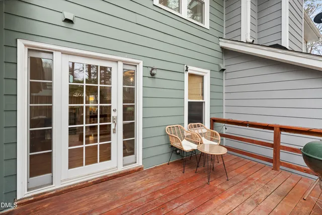 a wooden bench sitting in front of a building