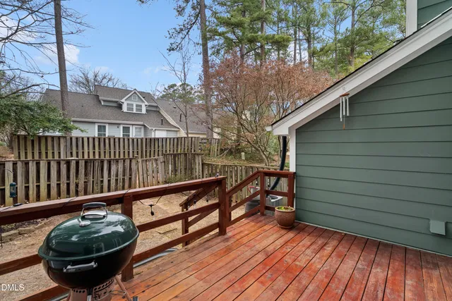 a view of balcony with wooden floor and fence