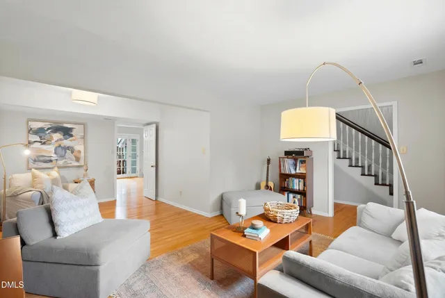 a living room with furniture and wooden floor