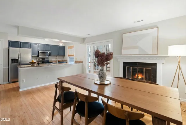 a kitchen with a table chairs refrigerator and microwave