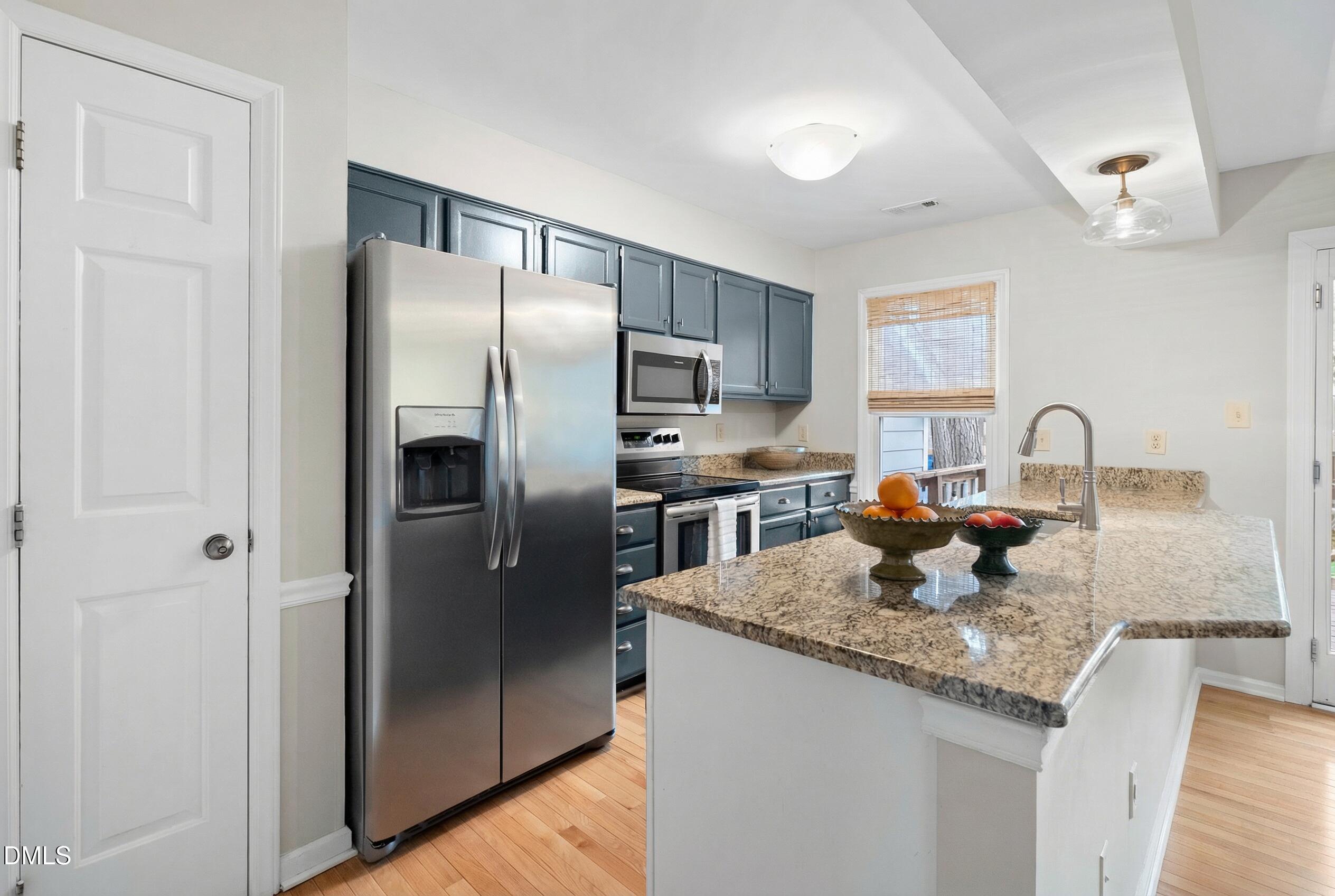 1515 Hemphill Drive Raleigh, NC 27609 - Photo 6 of 46 a kitchen with granite countertop stainless steel appliances a refrigerator a stove a sink and a refrigerator