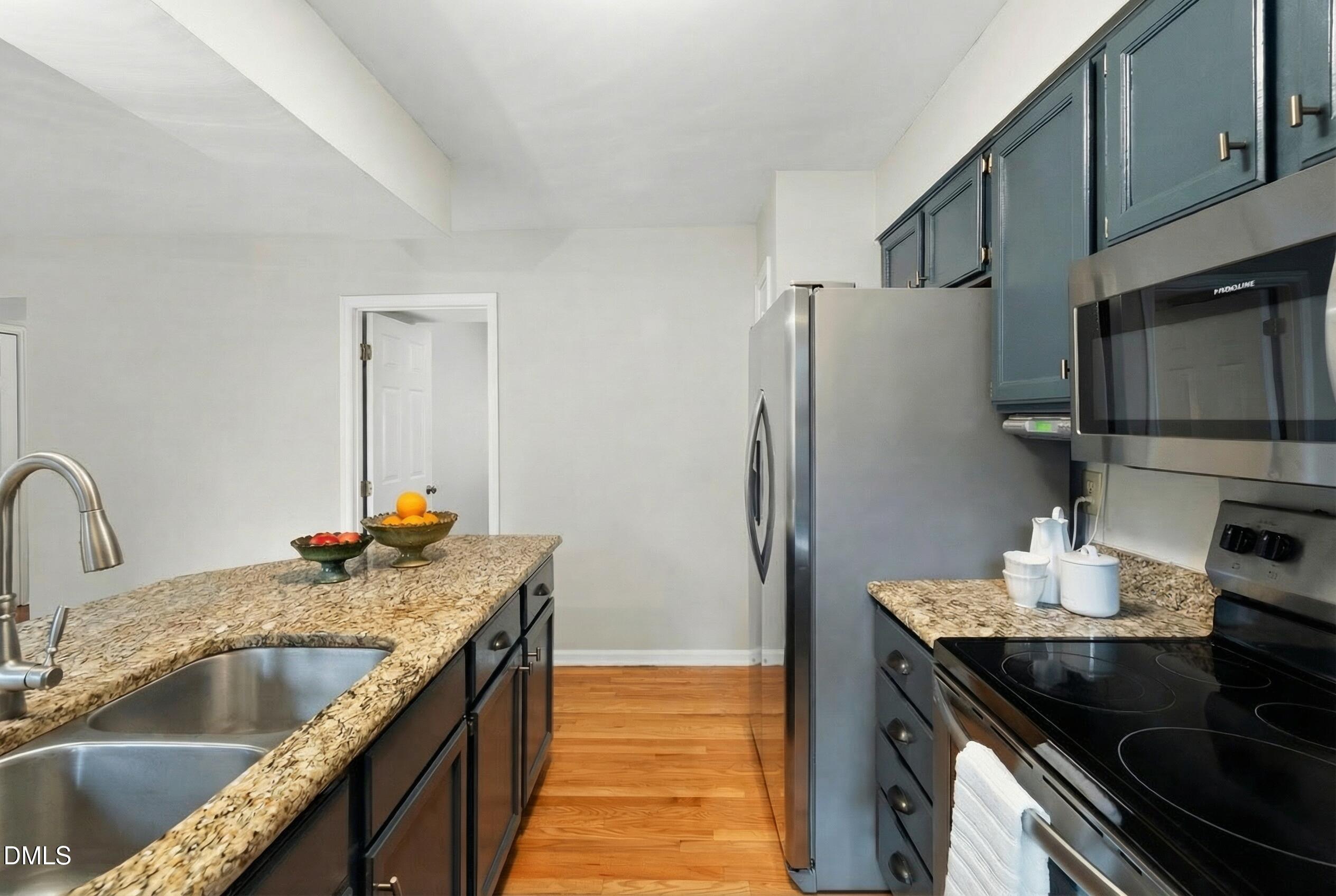 1515 Hemphill Drive Raleigh, NC 27609 - Photo 8 of 46 a kitchen with stainless steel appliances granite countertop a sink stove and refrigerator