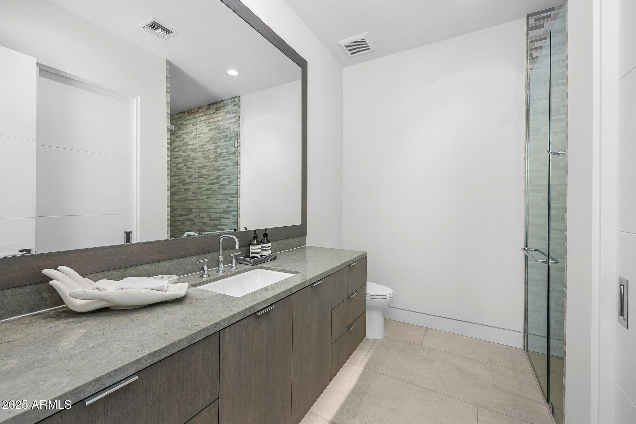6149 East Indian Bend Road Paradise Valley, AZ 85253 - Photo 43 of 77 a bathroom with a granite countertop sink and a mirror