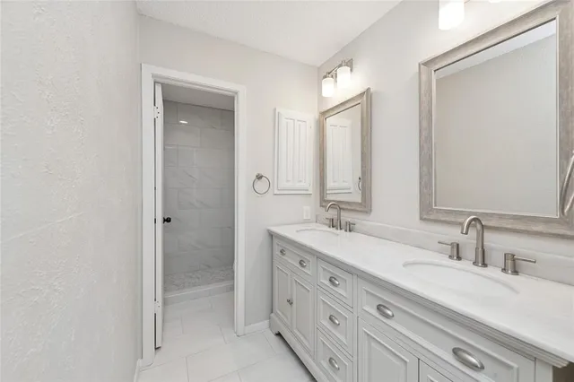 a bathroom with double sink and a mirror