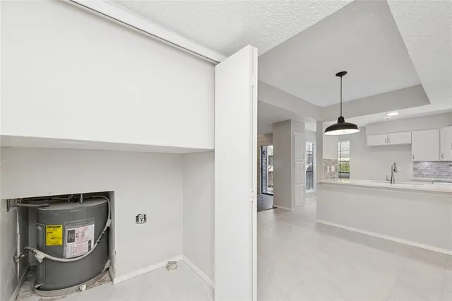 a kitchen with sink and cabinets