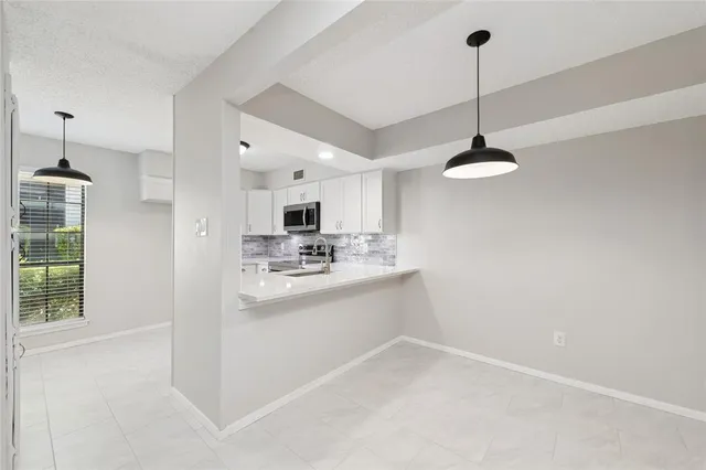 a kitchen with stainless steel appliances kitchen island sink refrigerator and stove