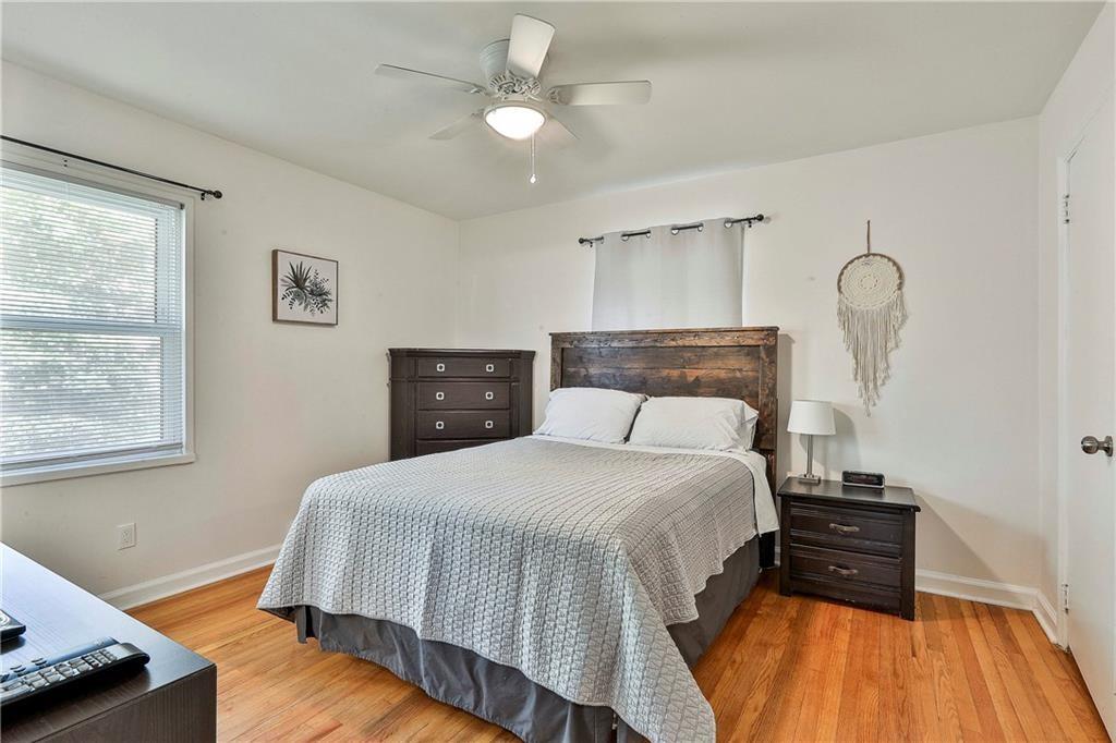 2037 B Lively Ridge Road Northeast Atlanta, GA 30329 - Photo 13 of 18 a bedroom with a bed and wooden floor