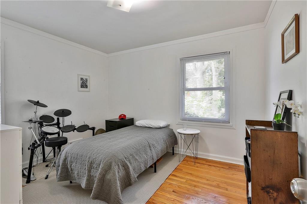 2037 B Lively Ridge Road Northeast Atlanta, GA 30329 - Photo 16 of 18 a spacious bedroom with a bed and wooden floor