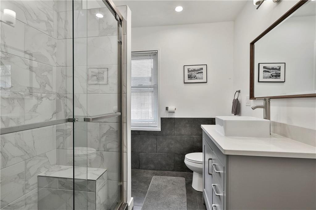 2037 B Lively Ridge Road Northeast Atlanta, GA 30329 - Photo 17 of 18 a bathroom with a toilet sink and shower