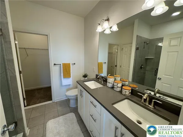 a bathroom with a sink double vanity granite and a mirror