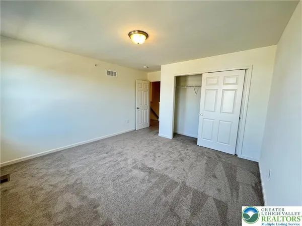 an empty room with closet area