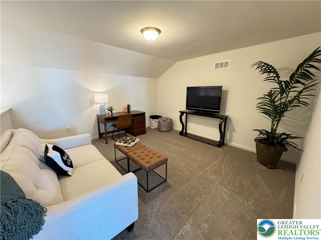 113 Timber Trail, Unit 54 Easton, PA 18045 - Photo 20 of 24 a living room with furniture and a flat screen tv