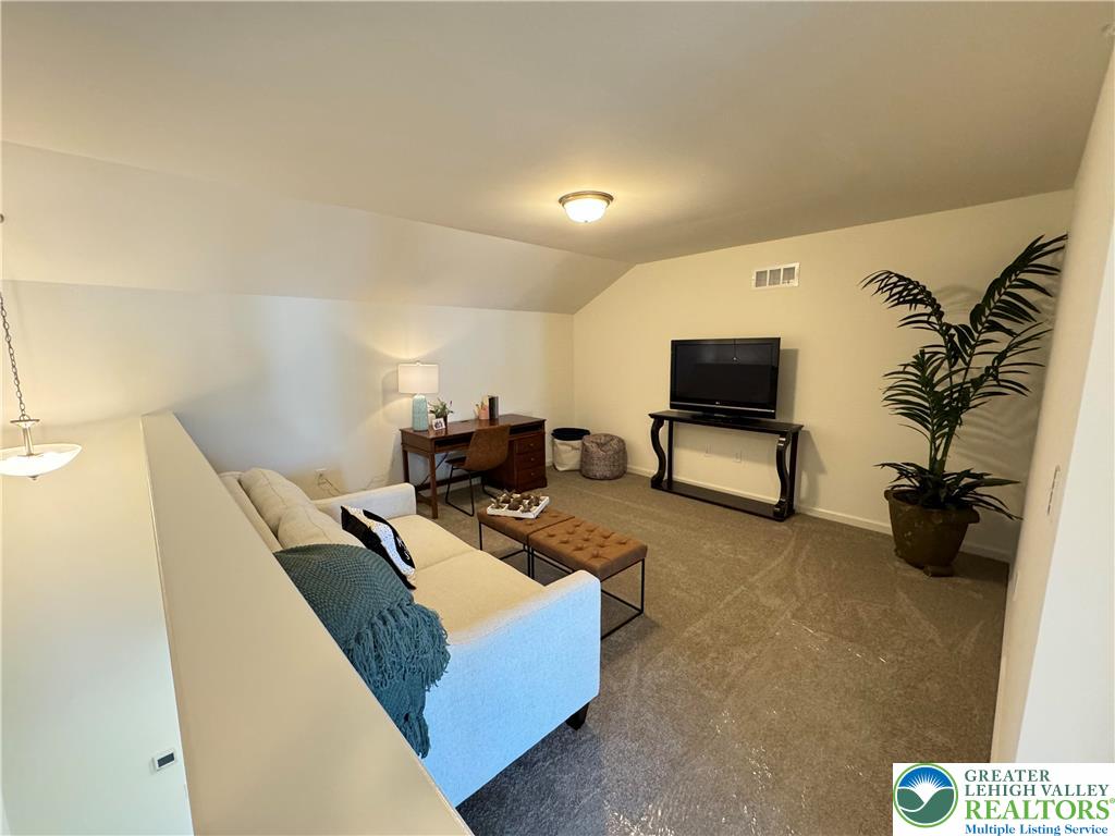 113 Timber Trail, Unit 54 Easton, PA 18045 - Photo 21 of 24 a living room with furniture and a flat screen tv