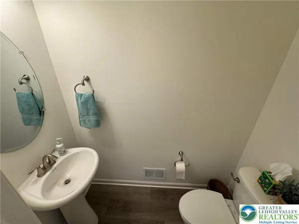 a bathroom with a sink mirror and toilet