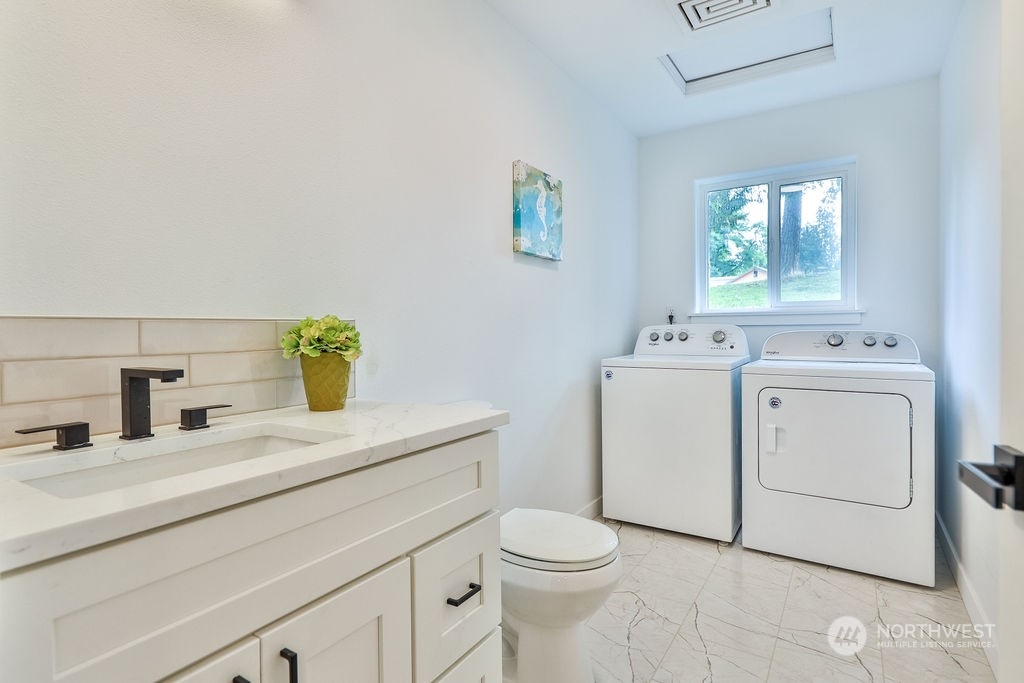 11026 Trombley Road Snohomish, WA 98290 - Photo 23 of 30 a bathroom with a sink toilet and window
