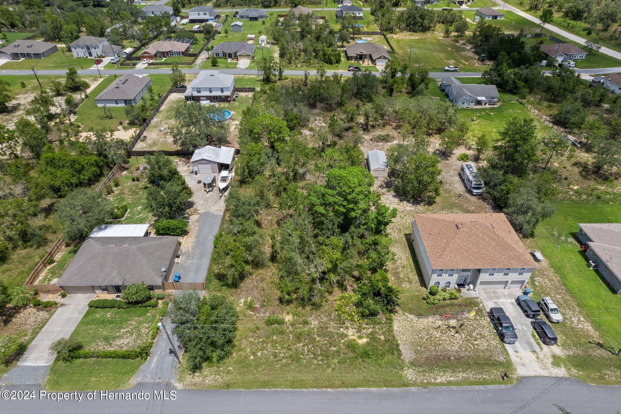 an aerial view of a house with yard swimming pool and outdoor seating