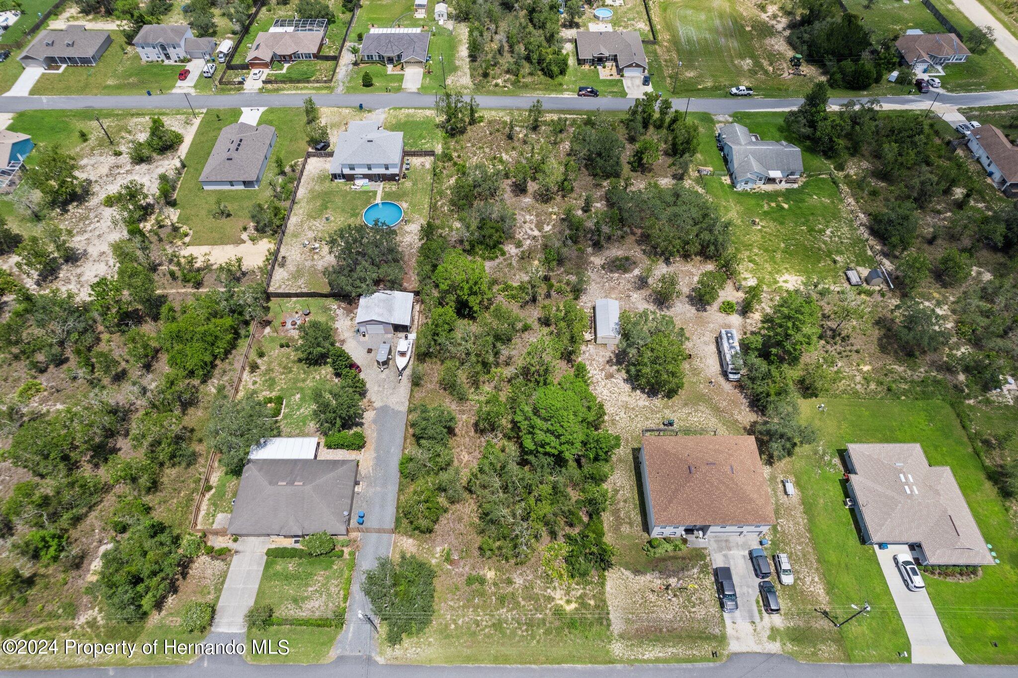 0 House Finch Road Weeki Wachee, FL 34614 - Photo 3 of 13 an aerial view of residential houses with outdoor space and trees