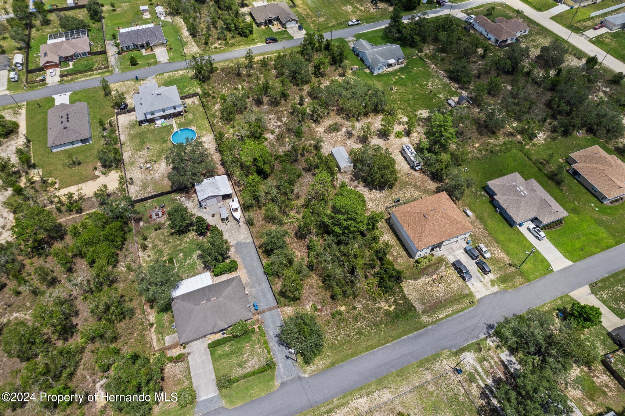 0 House Finch Road Weeki Wachee, FL 34614 - Photo 5 of 13 an aerial view of residential houses with outdoor space