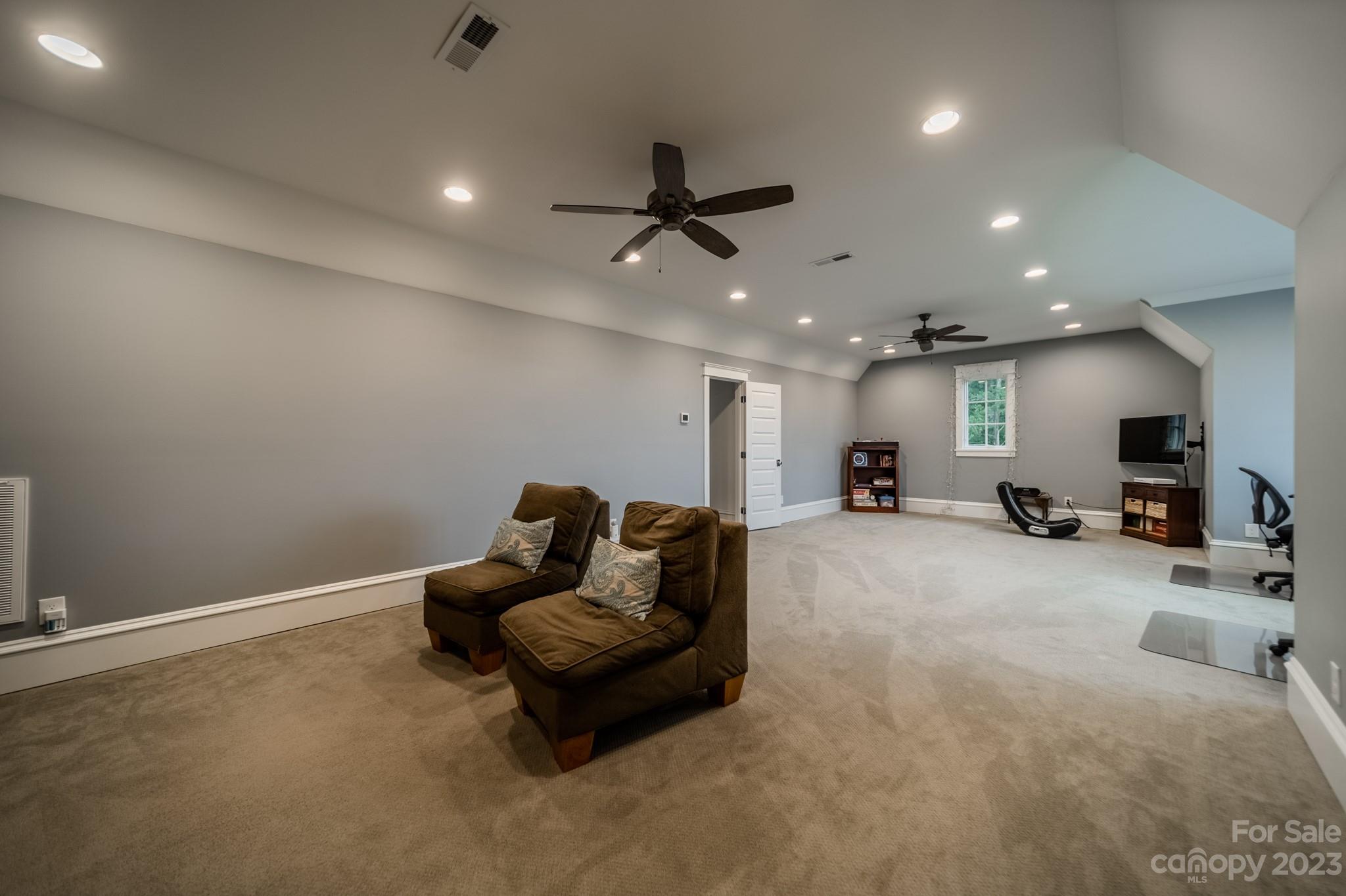 721 Lester Davis Road Waxhaw, NC 28173 - Photo 12 of 48 a living room with furniture and a ceiling fan