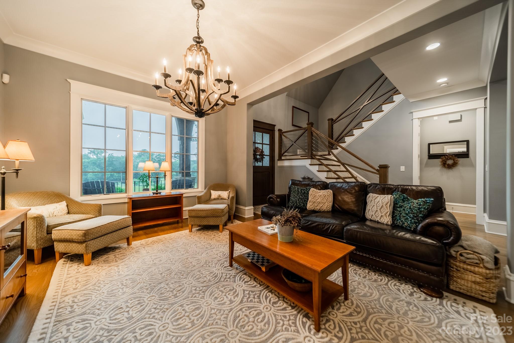 721 Lester Davis Road Waxhaw, NC 28173 - Photo 16 of 48 a living room with furniture and a chandelier