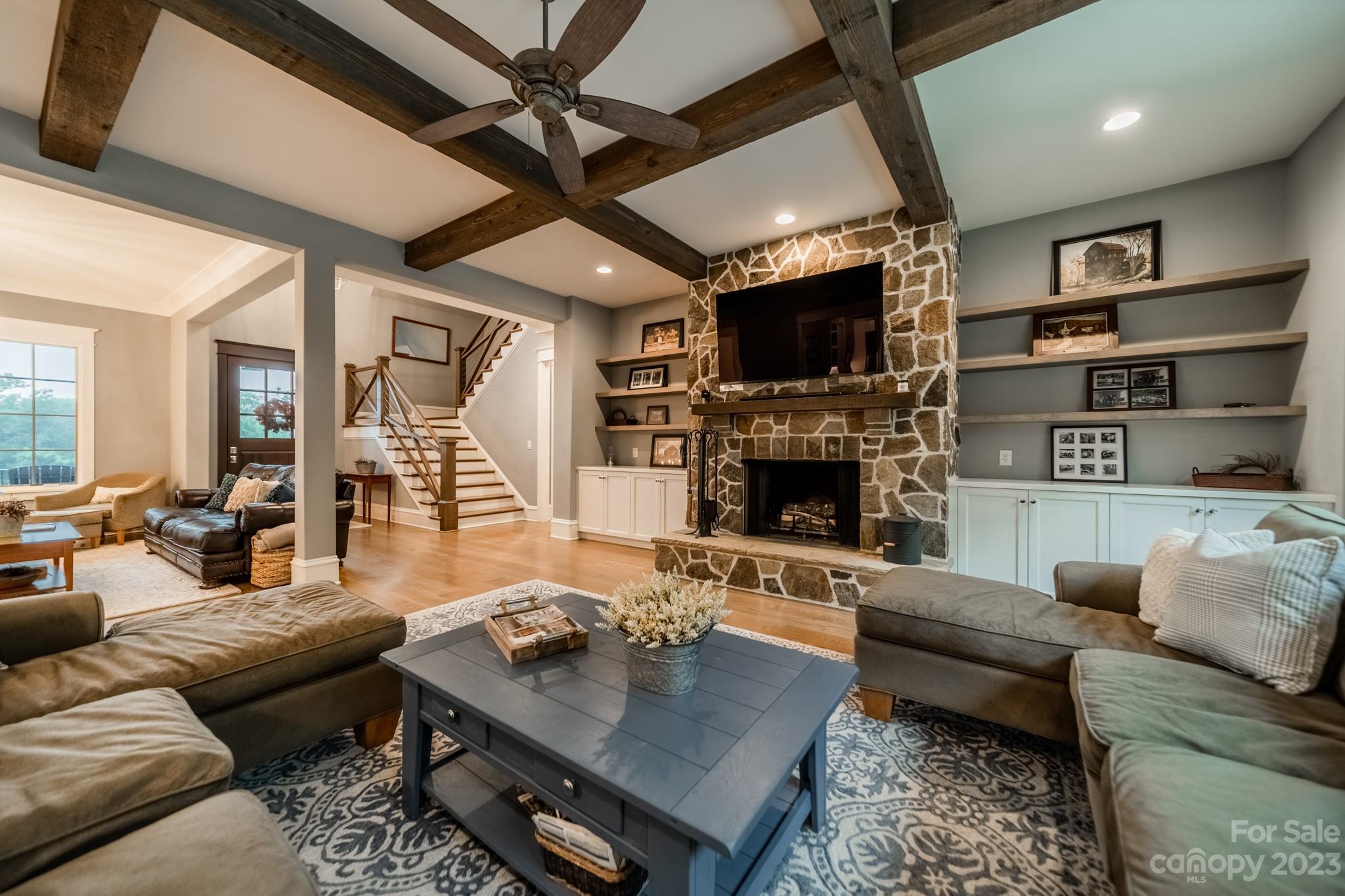 721 Lester Davis Road Waxhaw, NC 28173 - Photo 17 of 48 a living room with furniture a flat screen tv and a fireplace