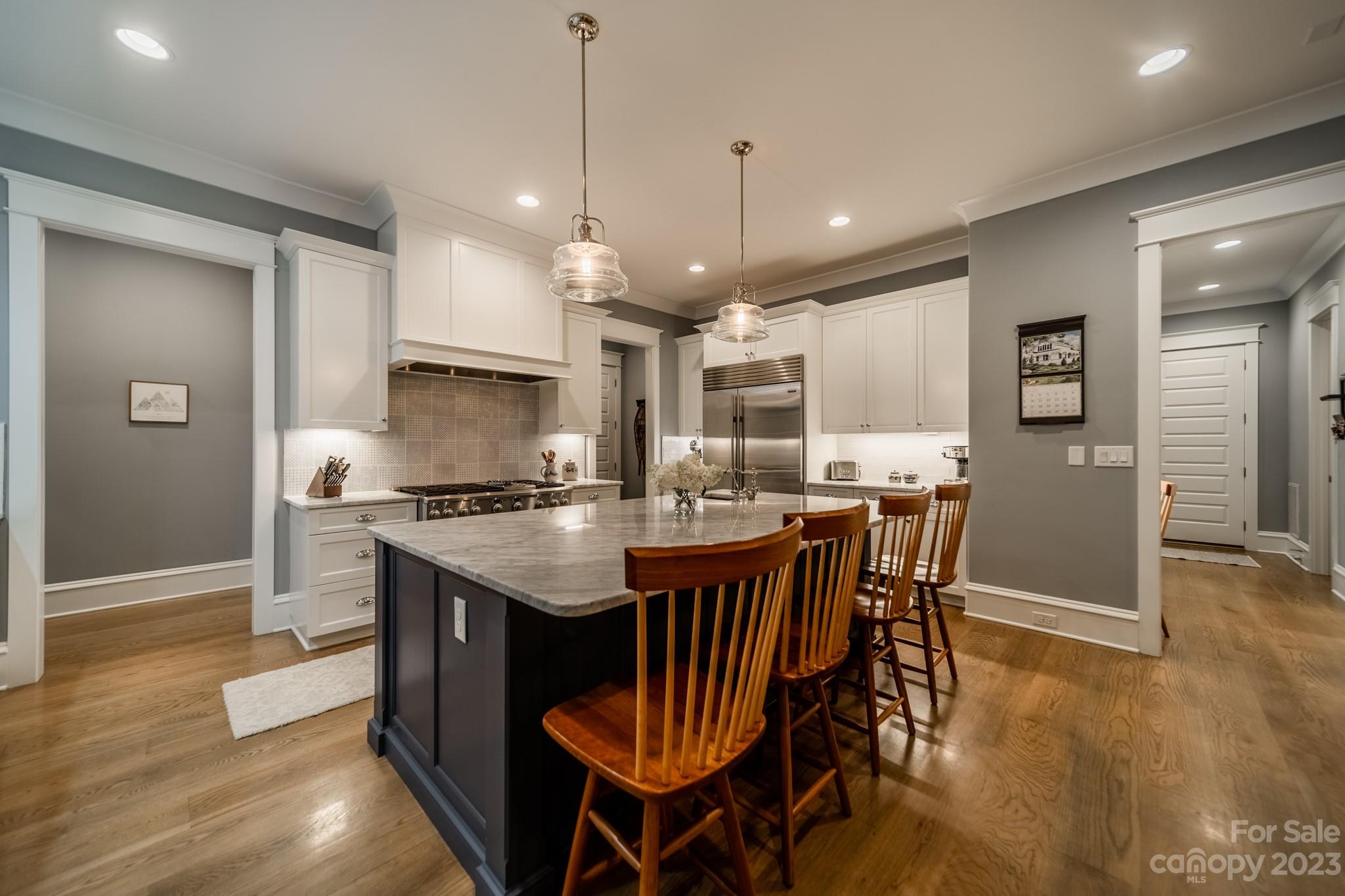 721 Lester Davis Road Waxhaw, NC 28173 - Photo 20 of 48 a kitchen with stainless steel appliances granite countertop a stove a refrigerator a kitchen island a sink and a refrigerator