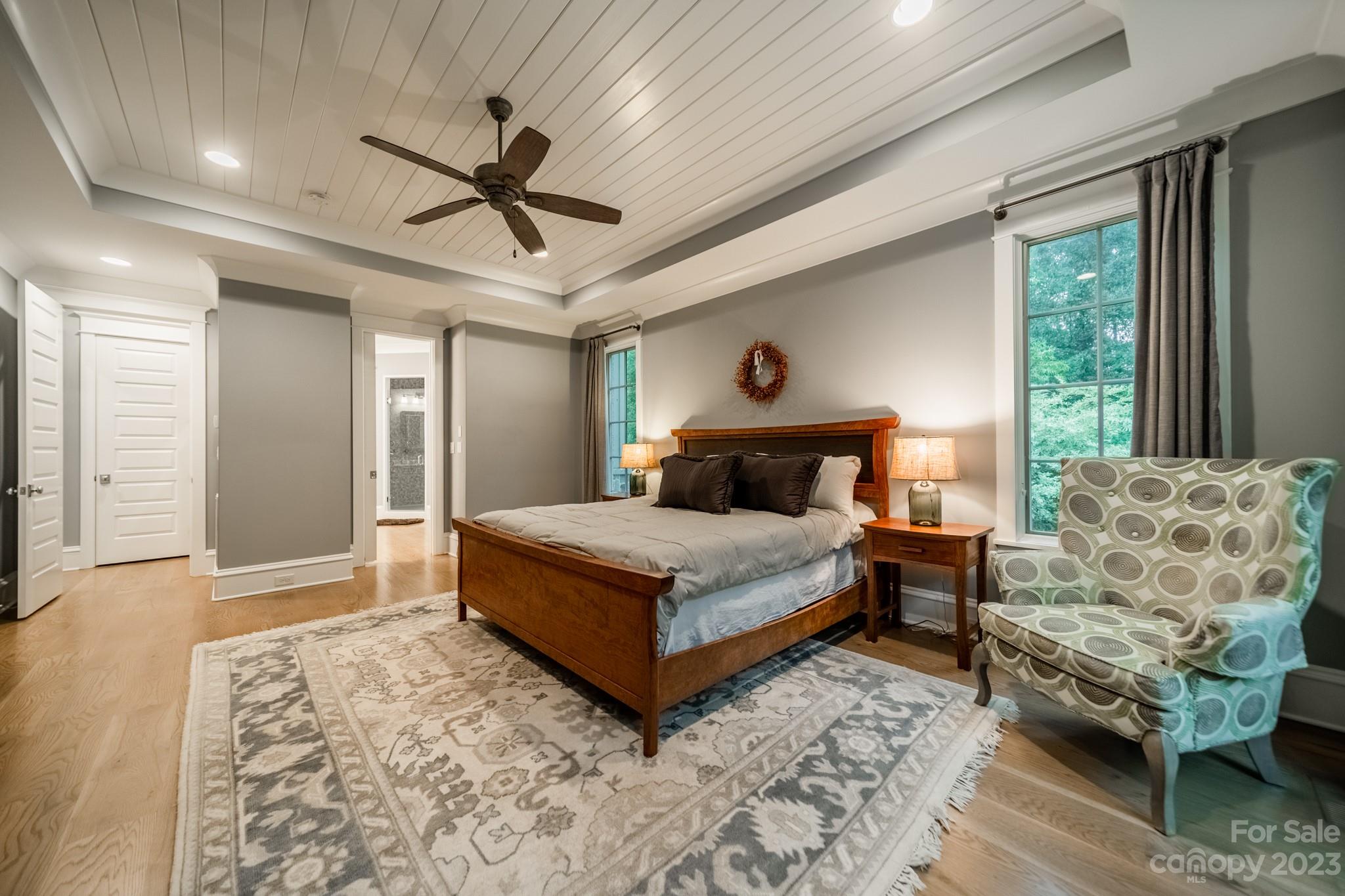 721 Lester Davis Road Waxhaw, NC 28173 - Photo 27 of 48 a bedroom with a bed lamp and a large window